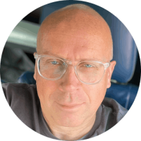 Seb Rogers - respected and experienced cycling journalist and photographer Headshot of Seb Rogers cycling journalist and photographer wearing glasses and smiling