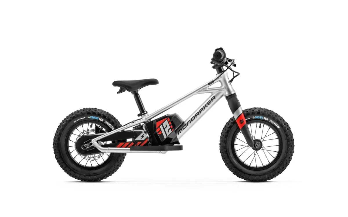 Studio photograph of a silver electric balance bike