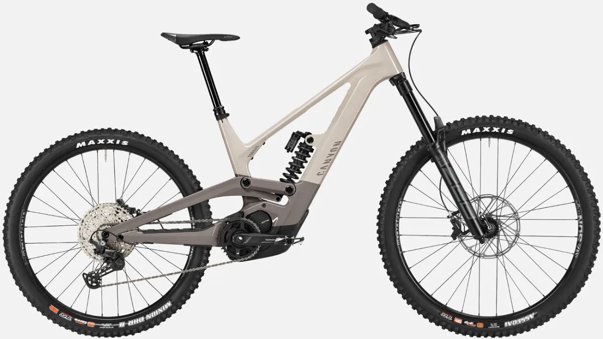 White and grey Canyon Torque ON CF7 full suspension mid motor e-mountain bike with long travel black forks