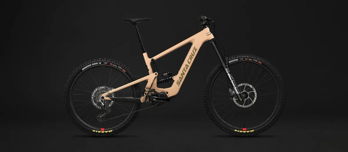 Pale orange Santa Cruz Bullit full suspension e-mountain bike with mid drive motor and black long-travel forks