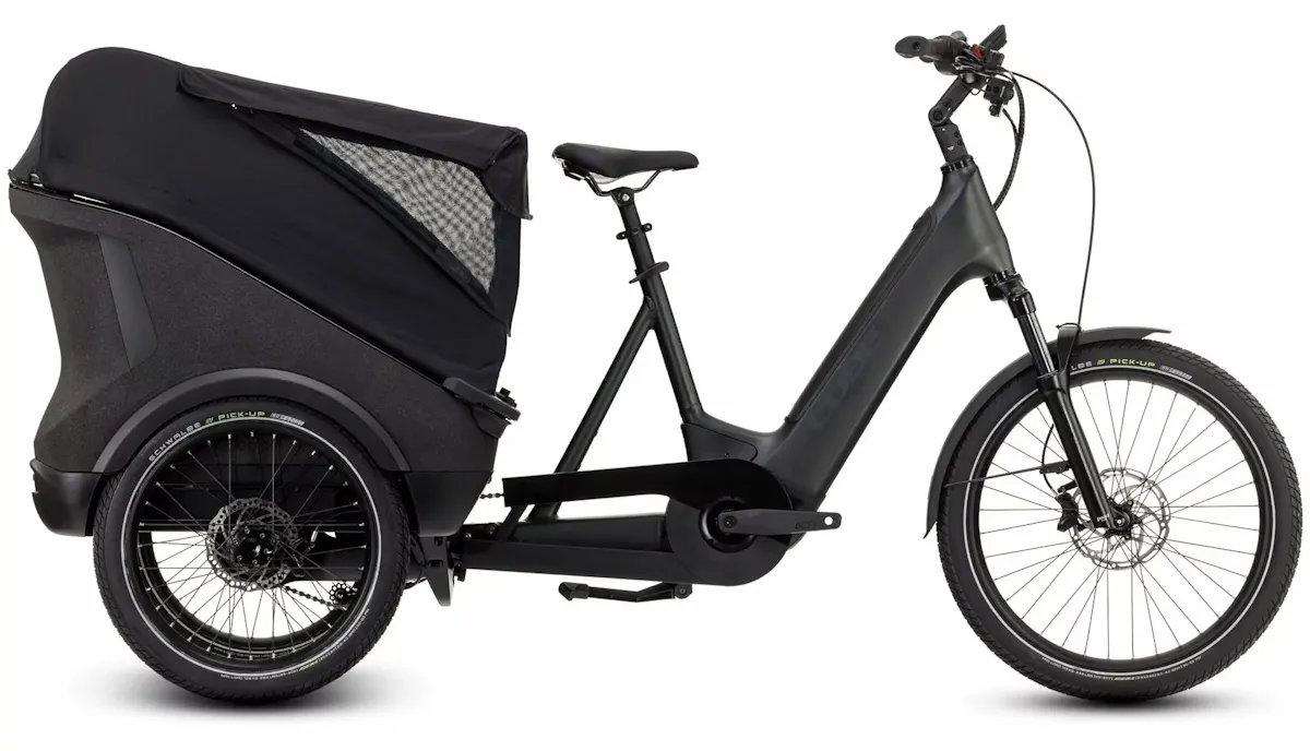 Black electric trike with twin rear wheels and rear load carrying area for children or luggage