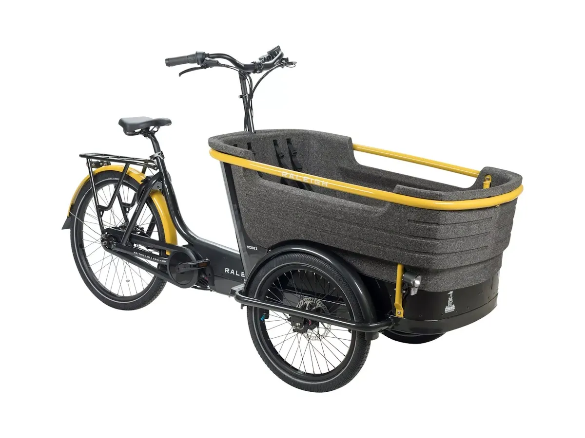 Black and yellow electric tricycle with large front load basket over twin front wheels