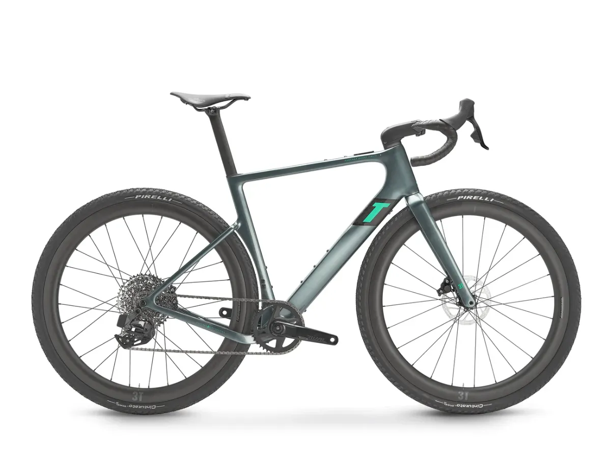 Studio photograph of a green electric gravel bike with integrated battery and wide rims