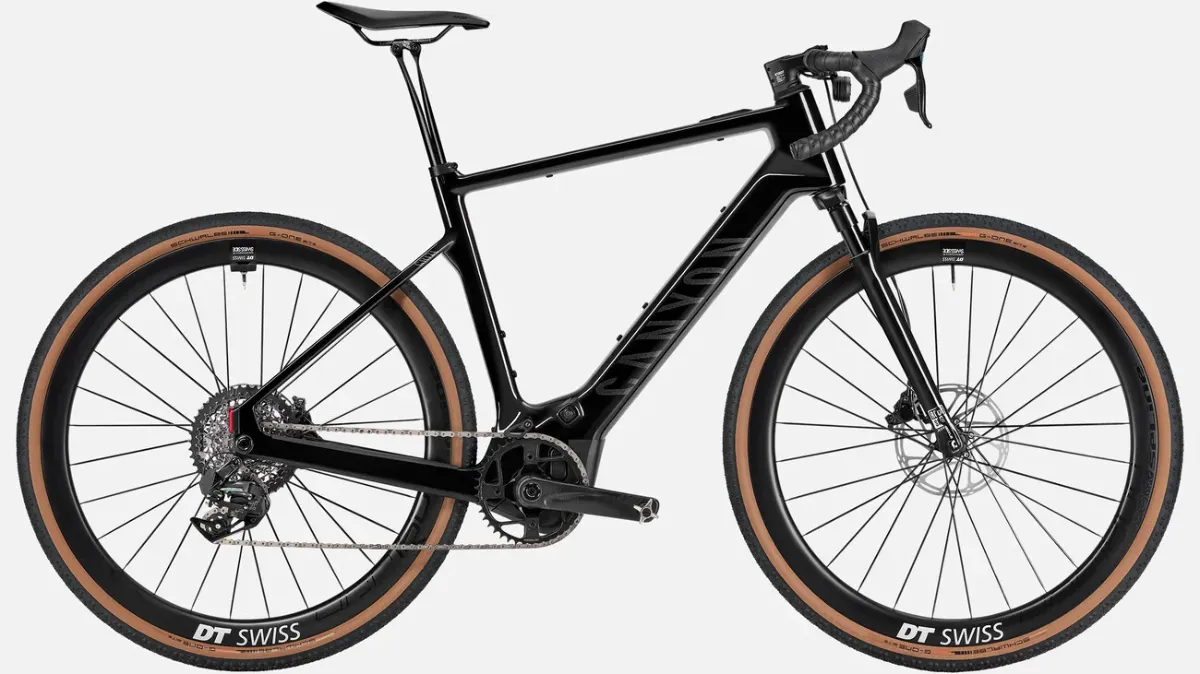 Studio photograph of a black mid-drive electric gravel bike with integrated battery