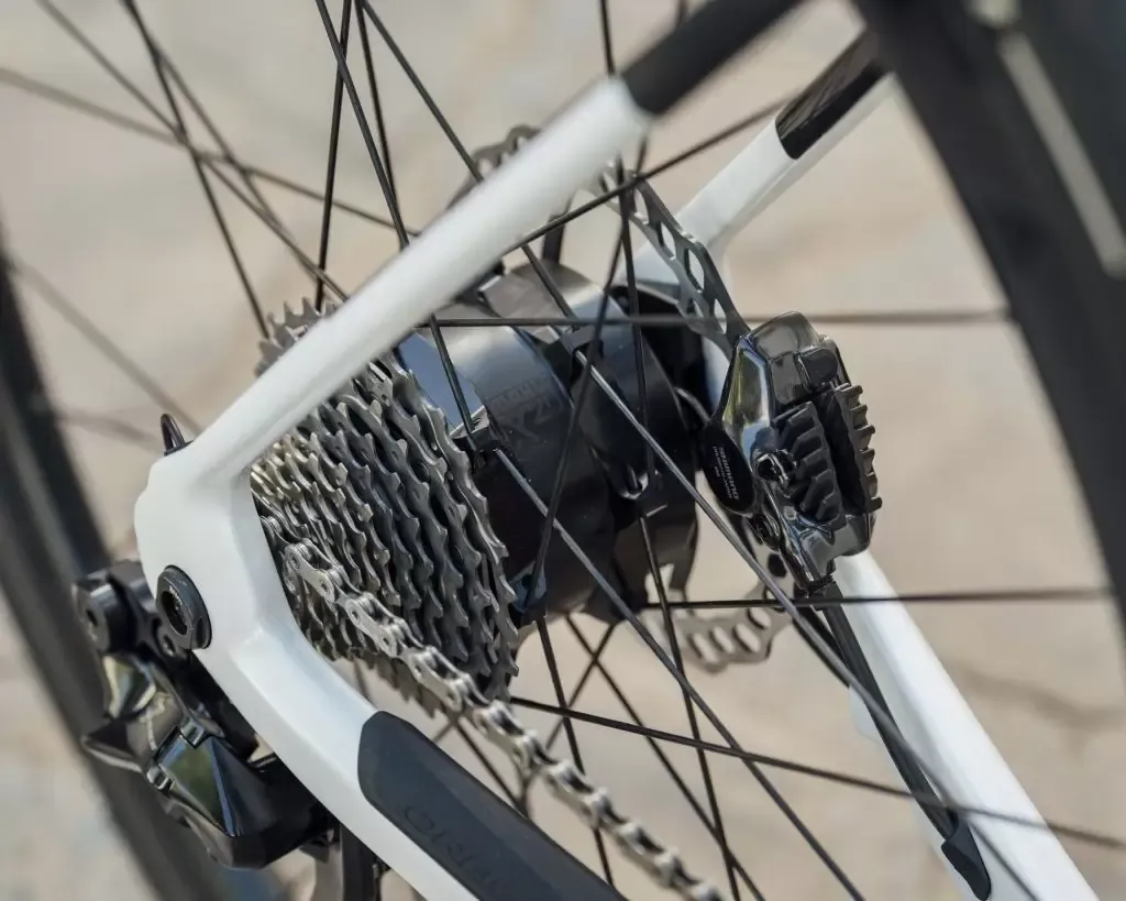Rear hub motor closeup with the rear wheel and white rear triangle of the e-bike in vie