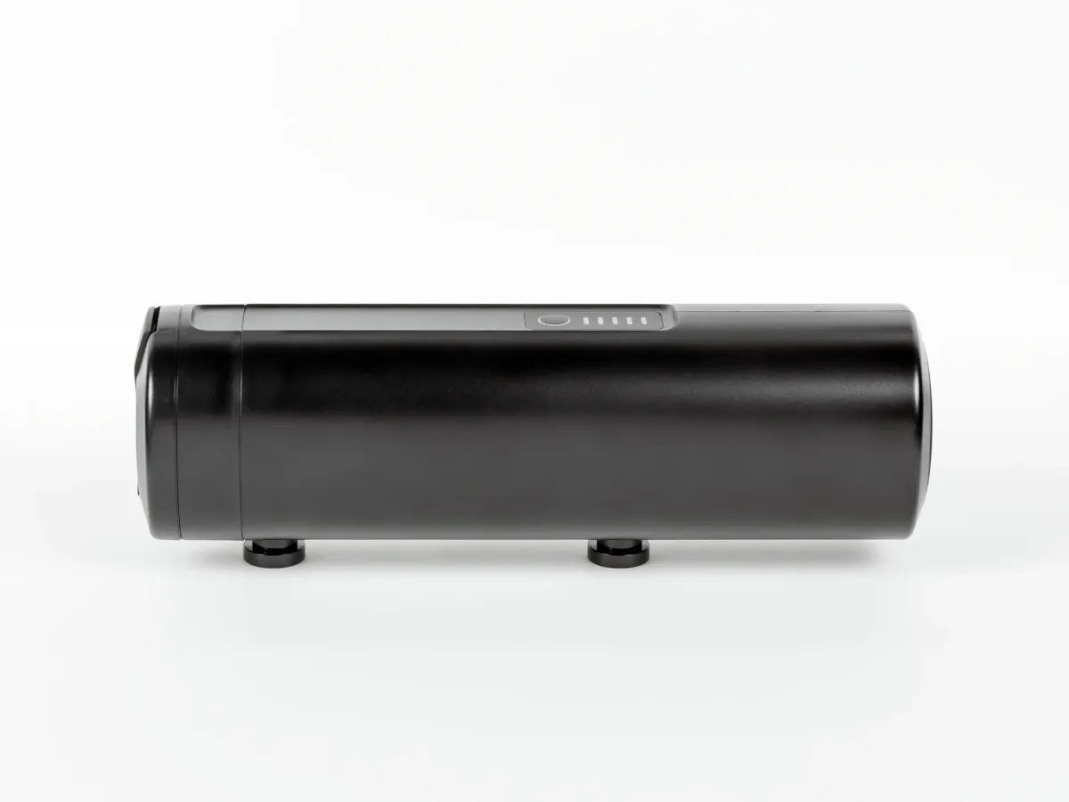 Black additional battery for electric bikes photographed in a studio